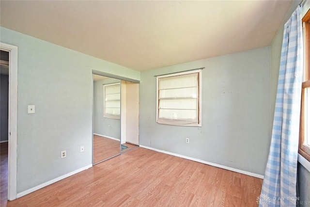 405 Parsons Ct, Englewood, OH 45322 - unfurnished bedroom featuring wood finished floors, a closet, and multiple windows