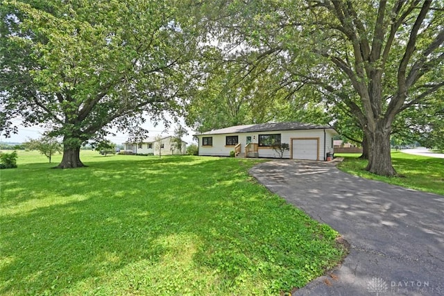 6383 Todhunter Rd, Middletown, OH 45044 - ranch-style home with asphalt driveway, a garage, and a front yard