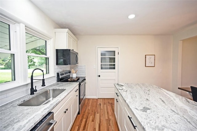 6383 Todhunter Rd, Middletown, OH 45044 - kitchen featuring stainless steel appliances, white cabinetry, light wood-type flooring, light stone countertops, and recessed lighting
