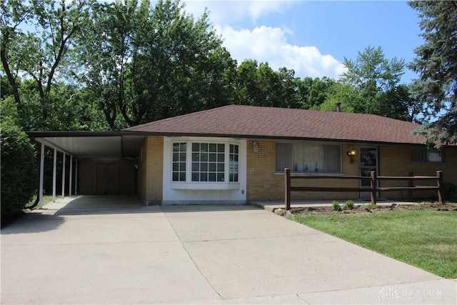 4912 Powell Rd, Huber Heights, OH 45424 - ranch-style house featuring brick siding, concrete driveway, and an attached carport