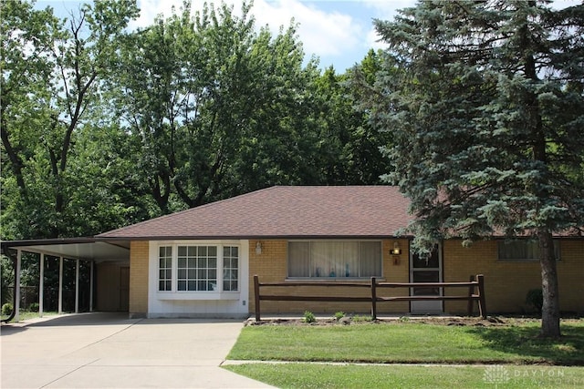 4912 Powell Rd, Huber Heights, OH 45424 - single story home featuring driveway, a carport, brick siding, and roof with shingles