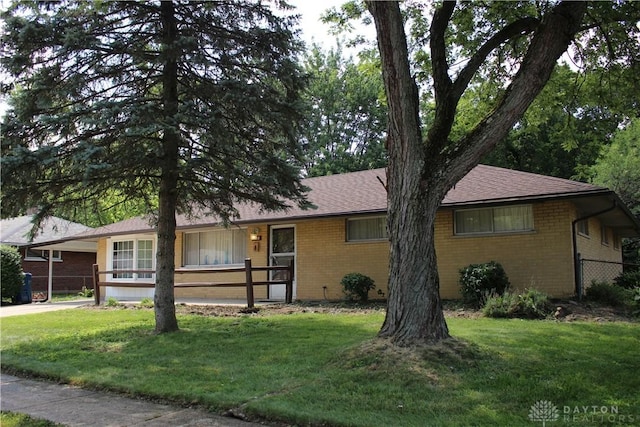 4912 Powell Rd, Huber Heights, OH 45424 - ranch-style house with brick siding, concrete driveway, roof with shingles, and an attached carport
