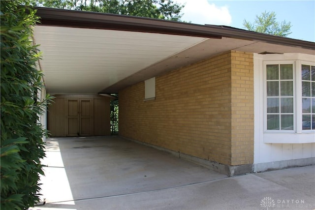 4912 Powell Rd, Huber Heights, OH 45424 - view of property exterior with an attached carport and brick siding