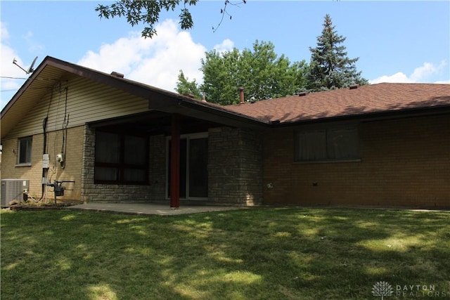 4912 Powell Rd, Huber Heights, OH 45424 - rear view of property featuring a yard, a patio area, brick siding, and a shingled roof