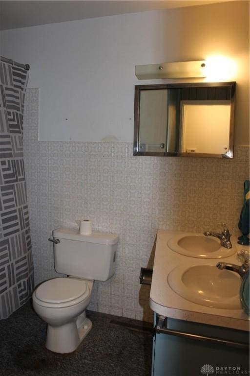 4912 Powell Rd, Huber Heights, OH 45424 - bathroom with a wainscoted wall, double vanity, and a shower with curtain