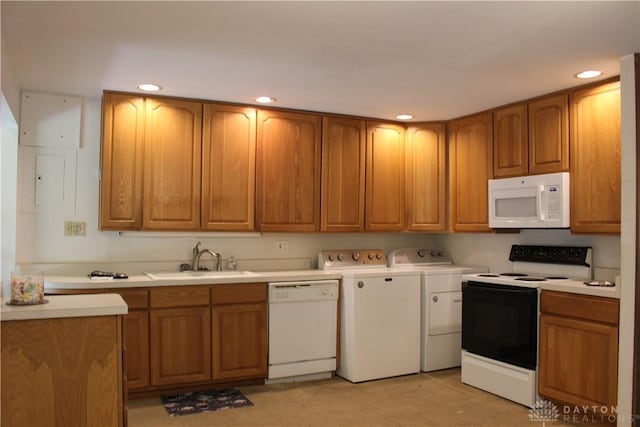 4912 Powell Rd, Huber Heights, OH 45424 - kitchen with white appliances, brown cabinets, recessed lighting, light countertops, and independent washer and dryer