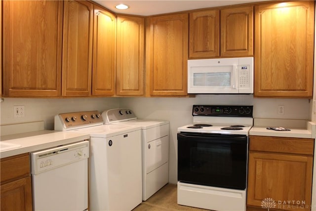 4912 Powell Rd, Huber Heights, OH 45424 - kitchen with white appliances, independent washer and dryer, light countertops, and brown cabinets