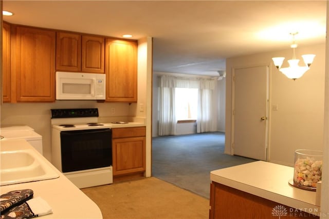 4912 Powell Rd, Huber Heights, OH 45424 - kitchen with white appliances, light colored carpet, washing machine and clothes dryer, brown cabinets, and recessed lighting