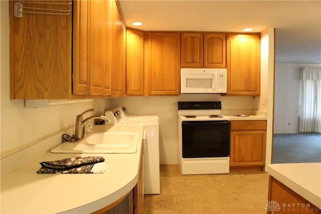 4912 Powell Rd, Huber Heights, OH 45424 - kitchen with white appliances, separate washer and dryer, light colored carpet, brown cabinetry, and recessed lighting