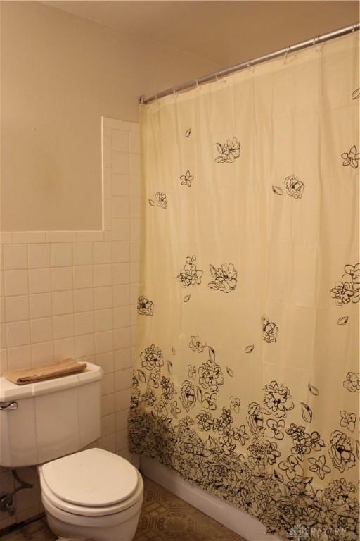 4912 Powell Rd, Huber Heights, OH 45424 - bathroom with tile walls and toilet