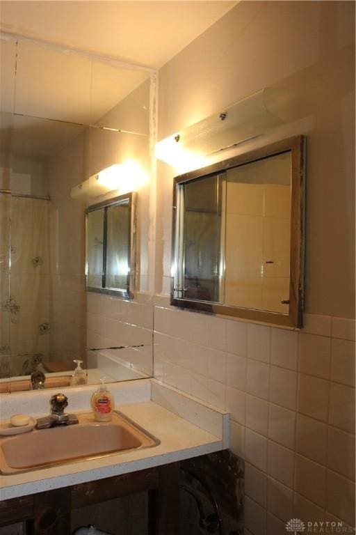 4912 Powell Rd, Huber Heights, OH 45424 - bathroom featuring tile walls, vanity, and backsplash