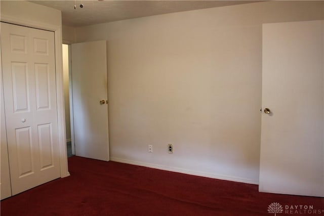 4912 Powell Rd, Huber Heights, OH 45424 - unfurnished bedroom featuring dark carpet and a closet