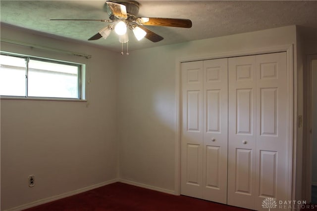 4912 Powell Rd, Huber Heights, OH 45424 - unfurnished bedroom with a closet, a ceiling fan, and dark colored carpet