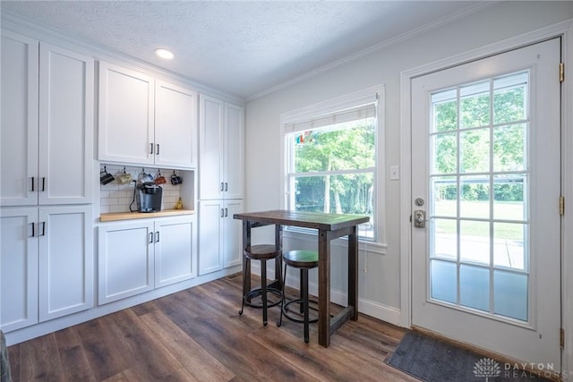 1097 Trudy Ct, Clearcreek Twp, OH 45036 - kitchen with dark wood-style flooring, white cabinets, crown molding, tasteful backsplash, and recessed lighting