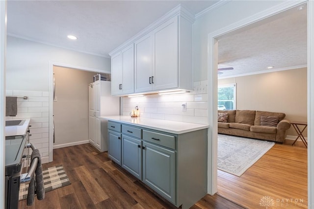 1097 Trudy Ct, Clearcreek Twp, OH 45036 - kitchen with white cabinets, dark wood-style floors, light countertops, stove, and decorative backsplash