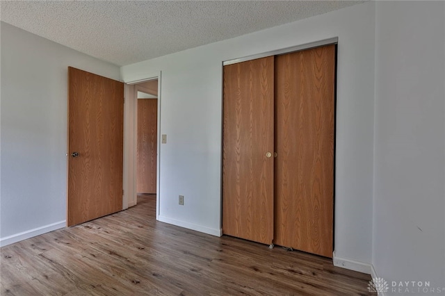 5979 Timbergate Trl, Dayton, OH 45424 - unfurnished bedroom featuring wood finished floors, a closet, and a textured ceiling