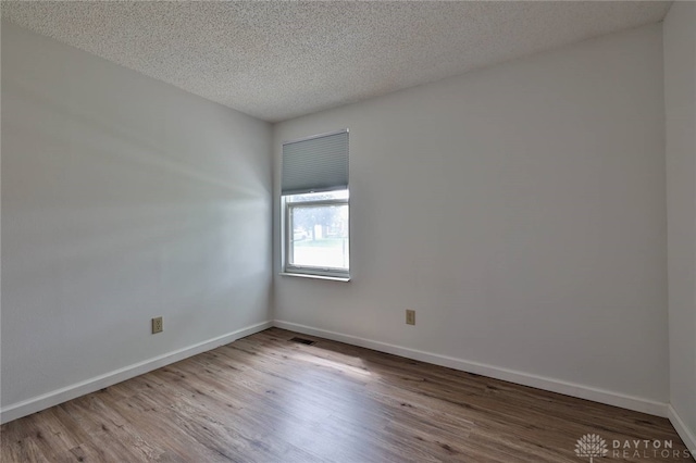 5979 Timbergate Trl, Dayton, OH 45424 - spare room with wood finished floors and a textured ceiling