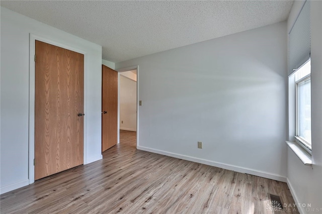 5979 Timbergate Trl, Dayton, OH 45424 - unfurnished bedroom featuring wood finished floors, a textured ceiling, and a closet
