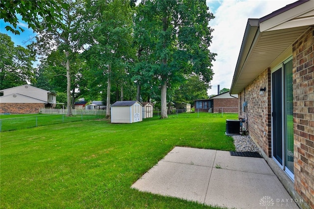 5979 Timbergate Trl, Dayton, OH 45424 - fenced backyard featuring a storage unit and a patio