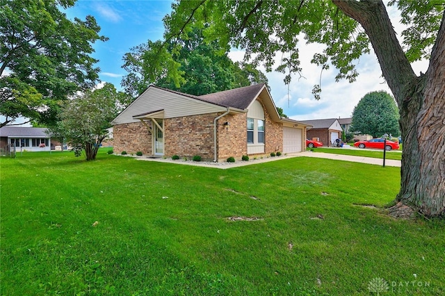 5979 Timbergate Trl, Dayton, OH 45424 - view of property exterior featuring a lawn, brick siding, a garage, and concrete driveway