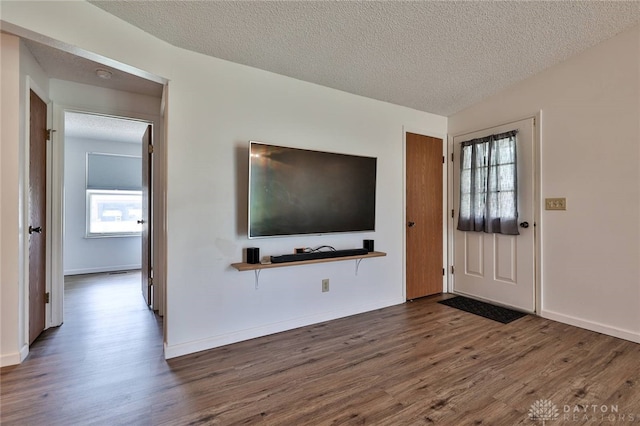 5979 Timbergate Trl, Dayton, OH 45424 - unfurnished living room featuring dark wood-style floors and a textured ceiling