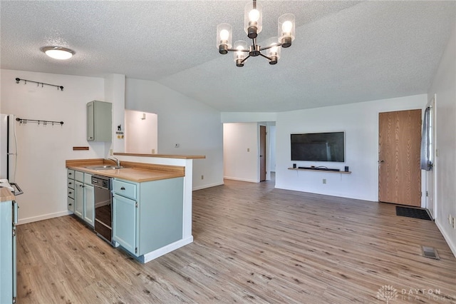 5979 Timbergate Trl, Dayton, OH 45424 - kitchen with a textured ceiling, blue cabinets, light wood finished floors, a chandelier, and open floor plan