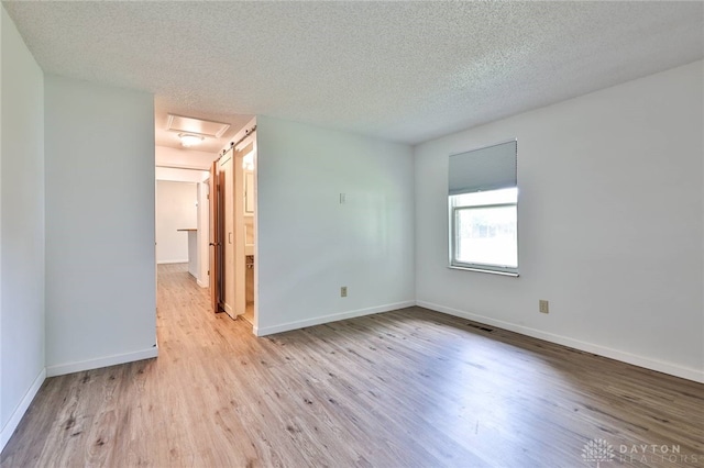 5979 Timbergate Trl, Dayton, OH 45424 - spare room with attic access, light wood-style flooring, and a textured ceiling