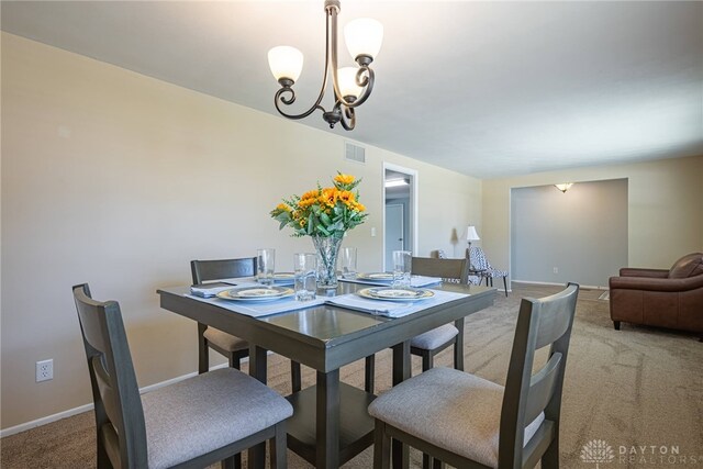 5970 Clearlake Dr, Dayton, OH 45424 - dining area featuring light carpet and a chandelier