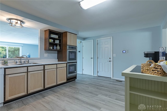 5970 Clearlake Dr, Dayton, OH 45424 - kitchen with light wood-type flooring, open shelves, light countertops, and stainless steel double oven