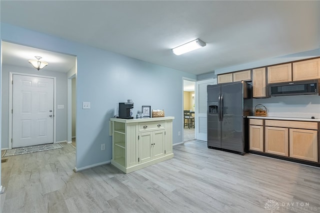 5970 Clearlake Dr, Dayton, OH 45424 - kitchen with black appliances, light wood finished floors, and light countertops