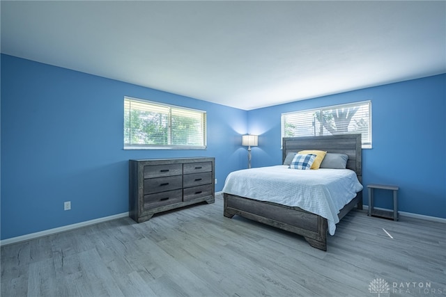 5970 Clearlake Dr, Dayton, OH 45424 - bedroom with multiple windows and wood finished floors