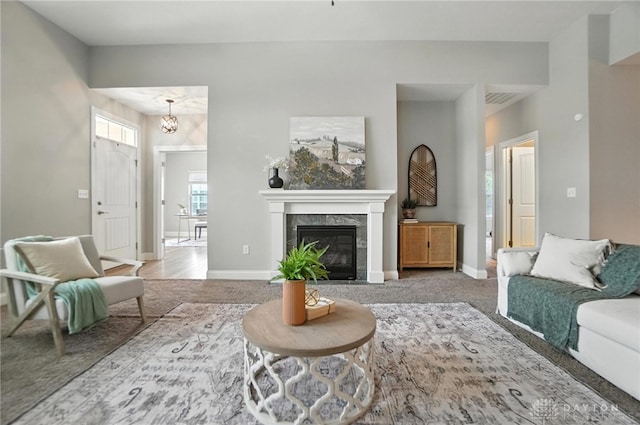 1310 Bourdeaux Way, Clearcreek Twp, OH 45458 - carpeted living area featuring a chandelier and a tiled fireplace