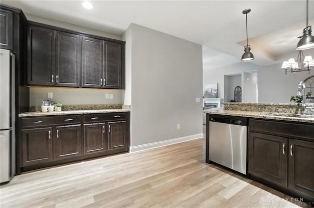 1310 Bourdeaux Way, Clearcreek Twp, OH 45458 - kitchen featuring stainless steel appliances, light wood-style flooring, recessed lighting, light stone counters, and decorative light fixtures