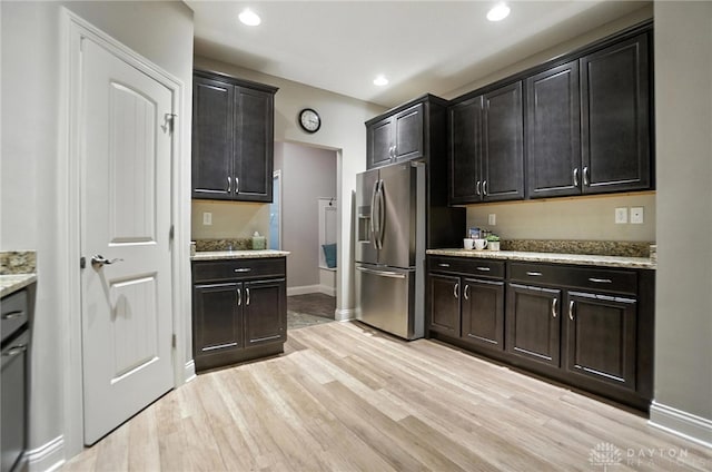 1310 Bourdeaux Way, Clearcreek Twp, OH 45458 - kitchen with stainless steel fridge, light wood-type flooring, light stone counters, and recessed lighting