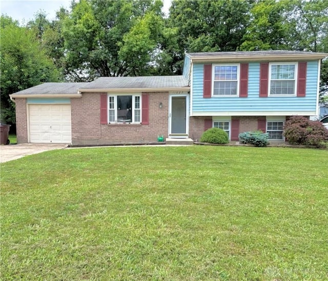 11629 Pippin Rd, Colerain Twp, OH 45231 - split level home with an attached garage, driveway, a front yard, and brick siding