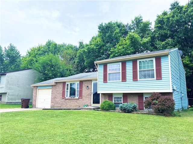 11629 Pippin Rd, Colerain Twp, OH 45231 - split level home featuring concrete driveway, an attached garage, a front yard, and brick siding