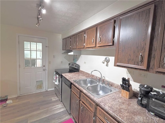 11629 Pippin Rd, Colerain Twp, OH 45231 - kitchen featuring stainless steel appliances, light wood-style flooring, under cabinet range hood, and a textured ceiling