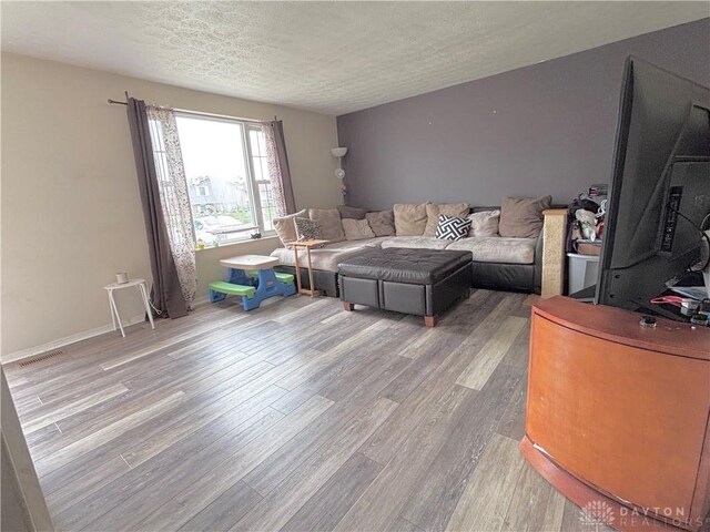 11629 Pippin Rd, Colerain Twp, OH 45231 - living area featuring wood finished floors and a textured ceiling
