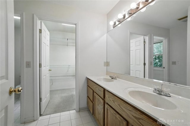 5567 Day Rd, Colerain Twp, OH 45252 - full bathroom featuring double vanity, tile patterned flooring, and a spacious closet