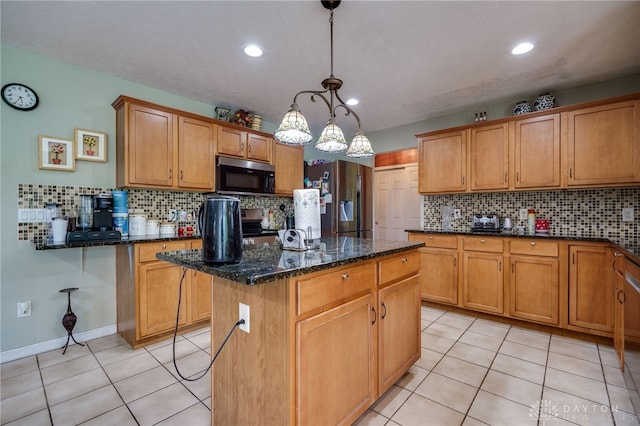 213 Bentridge Dr, Clearcreek Twp, OH 45458 - kitchen with a center island, stainless steel appliances, backsplash, light tile patterned floors, and dark stone counters