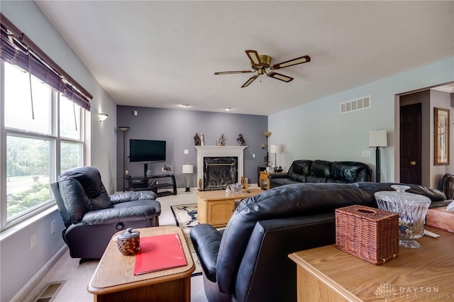213 Bentridge Dr, Clearcreek Twp, OH 45458 - living room with ceiling fan, a fireplace, and light colored carpet