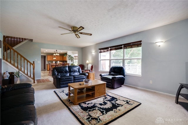 213 Bentridge Dr, Clearcreek Twp, OH 45458 - living area with light colored carpet, stairs, ceiling fan, and a textured ceiling