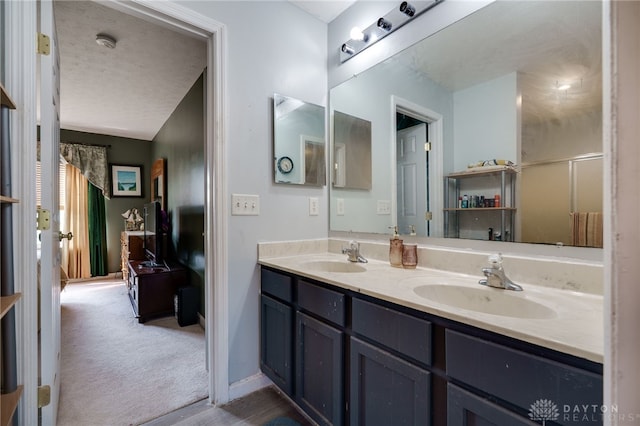 213 Bentridge Dr, Clearcreek Twp, OH 45458 - bathroom with double vanity, a textured ceiling, and lofted ceiling