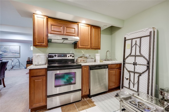 213 Bentridge Dr, Clearcreek Twp, OH 45458 - kitchen featuring stainless steel appliances, under cabinet range hood, brown cabinetry, and light tile patterned floors