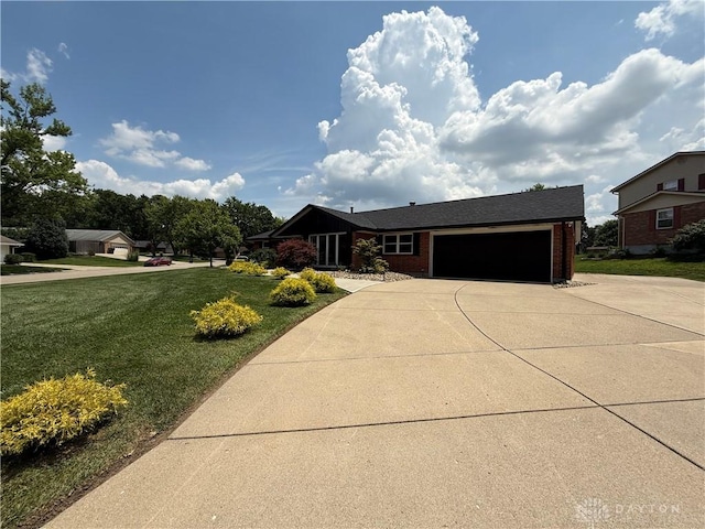 4220 Sillman Pl, Kettering, OH 45440 - view of front of property featuring an attached garage, driveway, brick siding, and a front lawn