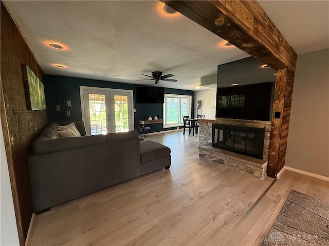 4220 Sillman Pl, Kettering, OH 45440 - living room featuring light wood-style flooring, french doors, a fireplace, and a ceiling fan