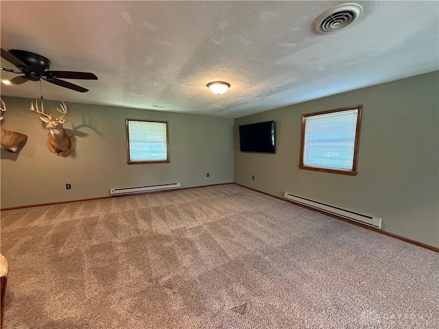 4220 Sillman Pl, Kettering, OH 45440 - spare room with baseboard heating, light colored carpet, and a textured ceiling