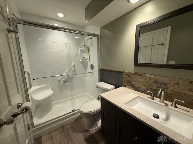 4220 Sillman Pl, Kettering, OH 45440 - full bath with a stall shower, wood finished floors, vanity, and decorative backsplash