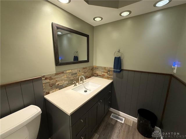 4220 Sillman Pl, Kettering, OH 45440 - bathroom with wainscoting, vanity, and wood finished floors