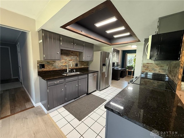 4220 Sillman Pl, Kettering, OH 45440 - kitchen with backsplash, a raised ceiling, light wood-type flooring, stainless steel dishwasher, and stove